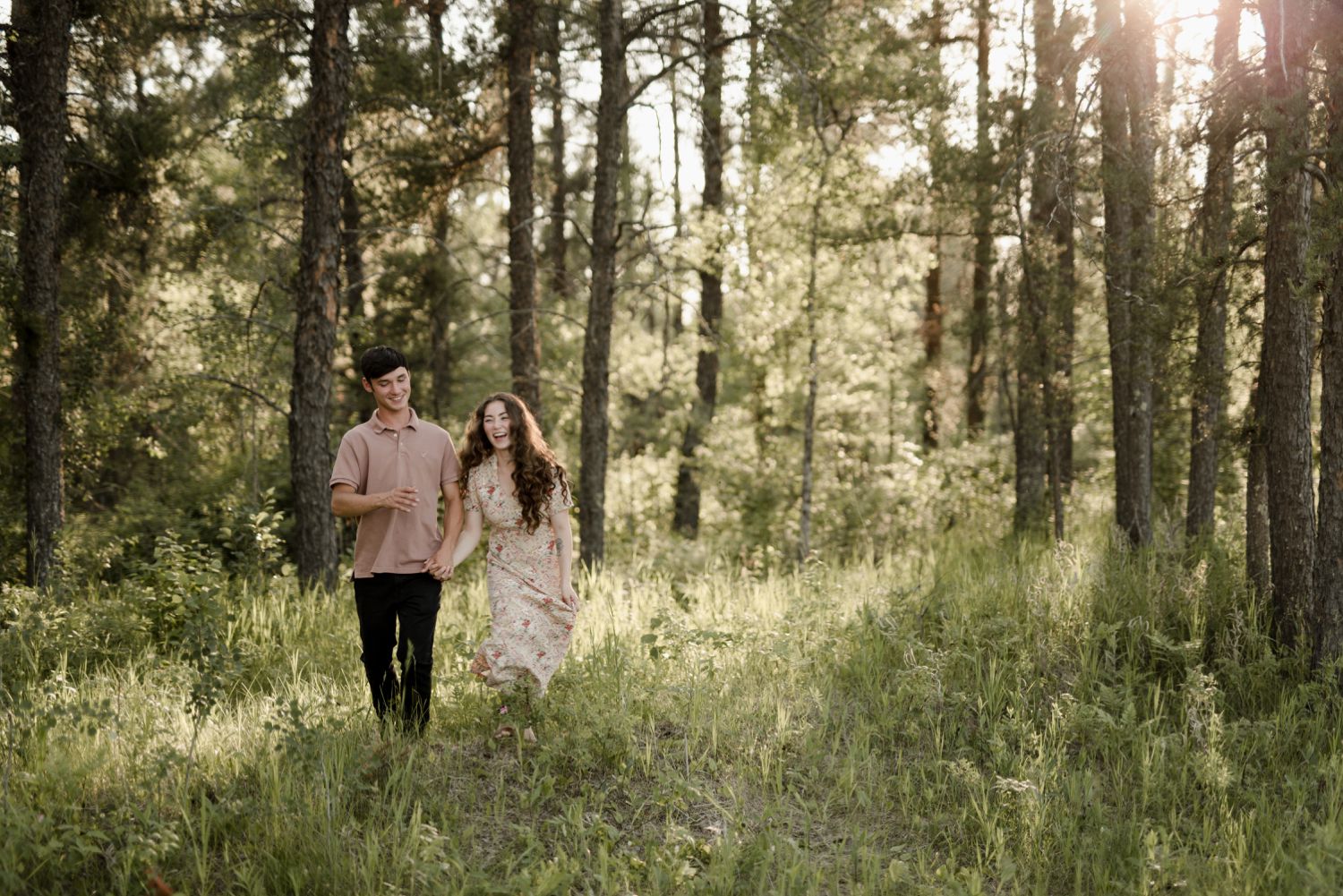 couple running through Sandilands, Manitoba for their engagement photos. Images taken by Vanessa Renae Photography, a winnipeg engagement photographer