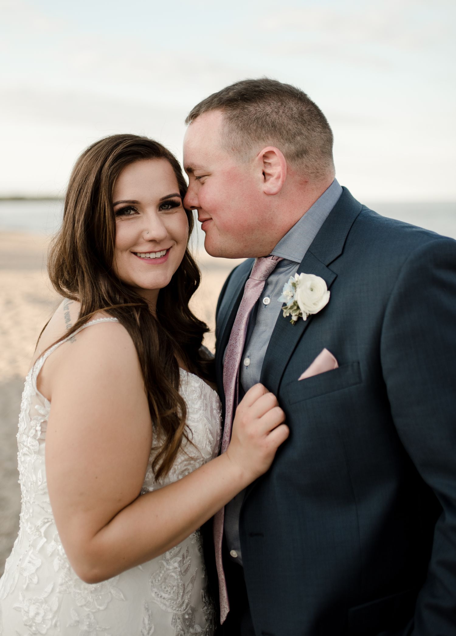 Gimli wedding couple on a beach at sunset, flowers by Stonehouse weddings, planned by Feast and festivities, photos by Vanessa Renae Photography, a winnipeg wedding and elopement photographer