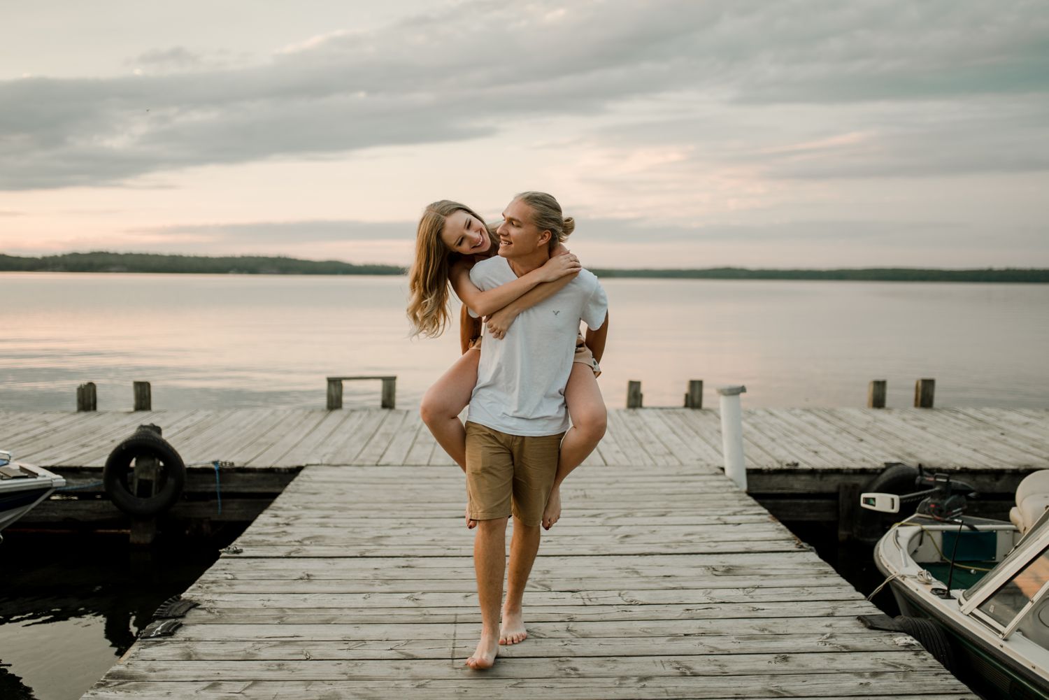 engaged couple walking on a dock together on their whiteshell engagement shoot. Photos by Vanessa Renae Photography, a Winnipeg and Kenora wedding photographer