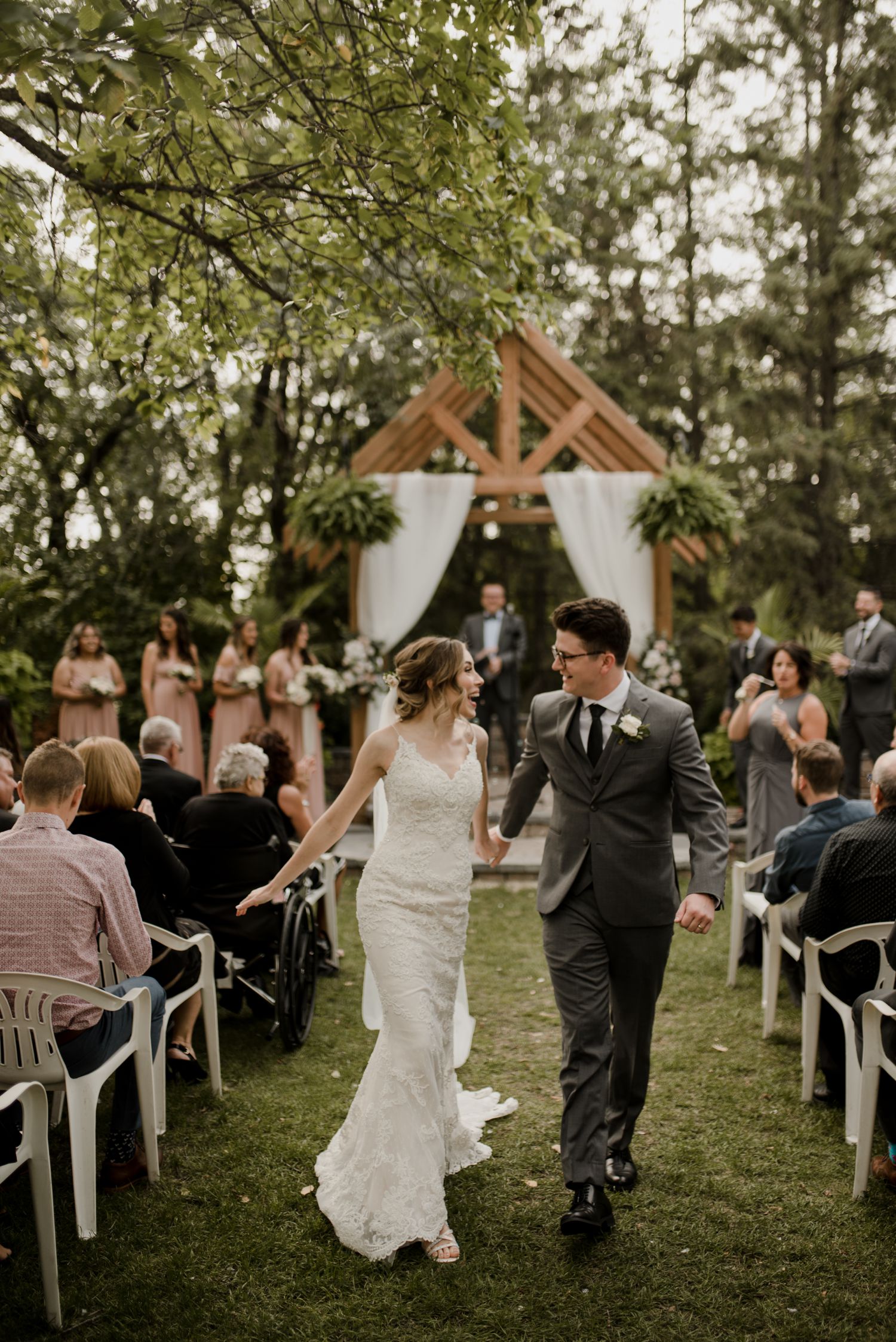 Shelby and Jesse celebrating their Evergreen village wedding in fall. Rustic boho wedding details. Photographed by Vanessa Renae Photography, a Winnipeg Wedding photographer