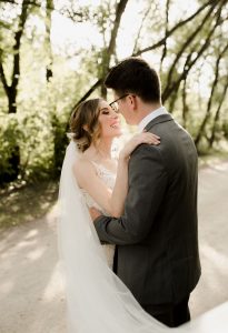 Shelby and Jesse celebrating their Evergreen village wedding in fall. Rustic boho wedding details. Photographed by Vanessa Renae Photography, a Winnipeg Wedding photographer