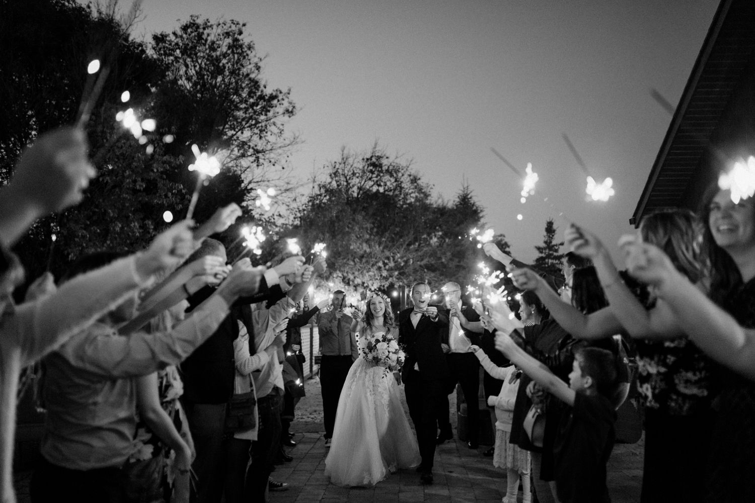 Ashgrove Acres Wedding in Winnipeg Manitoba, bridal flower crowns and fresh florals, photographed by Vanessa Renae Photography, a Winnipeg and Kenora wedding photographer. Sparkler exit at dusk on the Ashgrove Acres patio